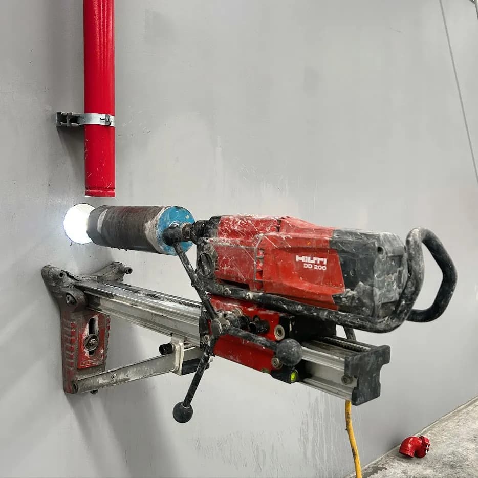 Perforadora Hilti DD 200 realizando una perforación con corona diamantada en muro de concreto